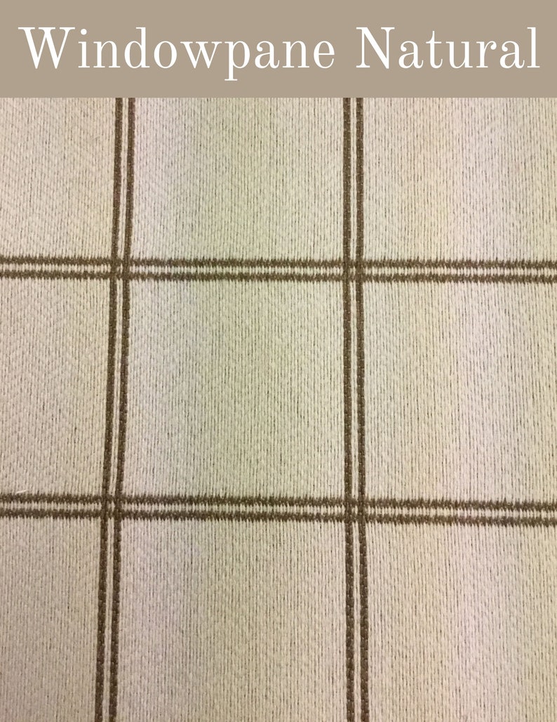 May include: Windowpane Natural fabric with a white background and brown stripes. The fabric has a woven texture.