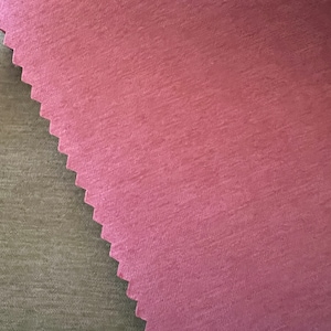 May include: Close-up of two fabric swatches. One is a textured, dusty rose color with a jagged edge. The other is a muted olive green. The fabrics have a subtle, brushed appearance.