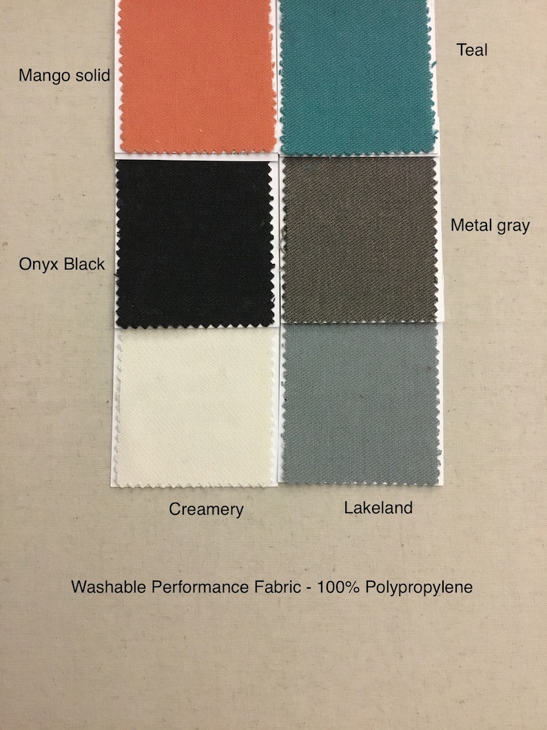 May include: Swatch card showing 10 fabric samples in various colors, including teal, mango solid, onyx black, metal gray, creamery, and lakeland. The card is labeled "Washable Performance Fabric - 100% Polypropylene".