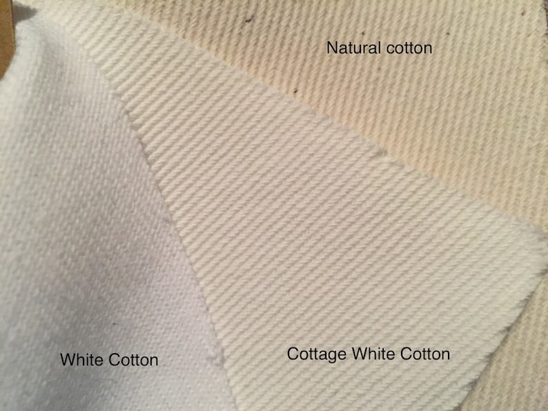 May include: Close-up of three cotton fabric samples. The samples are labelled "White Cotton", "Cottage White Cotton", and "Natural cotton". The fabrics display varying textures and shades of white and off-white.