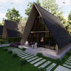 May include: An architectural rendering of modern A-frame houses with black corrugated metal roofs and large glass windows. The houses are surrounded by lush greenery, including trees, bushes, and a well-manicured lawn. A stone pathway leads to the front door.
