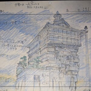 May include: A black and white pencil drawing of a multi-level building with a Japanese style roof. The building is drawn on a white sheet of paper with blue lines. The text "STUDIO GHIBLI" is written in the top left corner of the page. The text "すさま一人bookをな足しておきます" is written in the top right corner of the page.