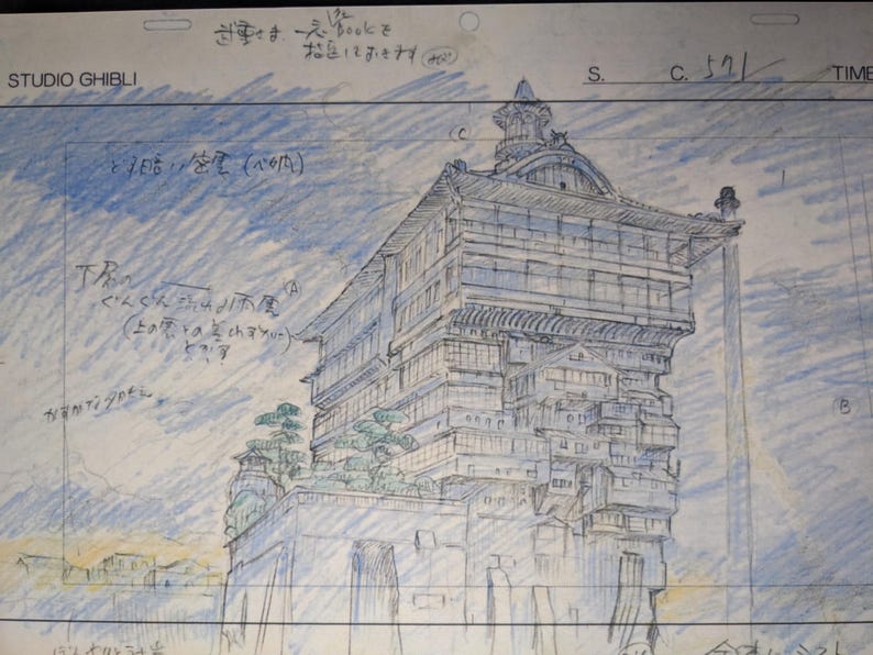 May include: A black and white pencil drawing of a multi-level building with a Japanese style roof. The building is drawn on a white sheet of paper with blue lines. The text "STUDIO GHIBLI" is written in the top left corner of the page. The text "すさま一人bookをな足しておきます" is written in the top right corner of the page.