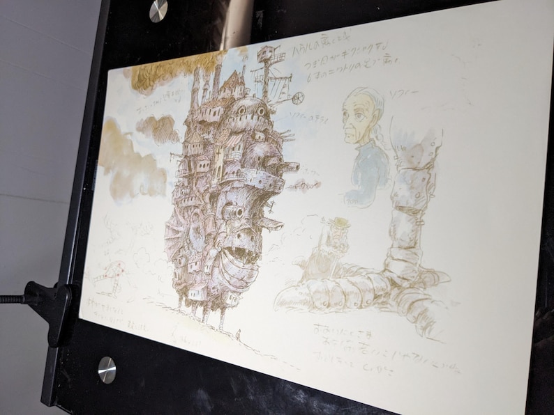 May include: A black and white pencil drawing of a flying city with a large, detailed structure. The drawing is on a white background with Japanese text.