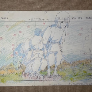 May include: A Studio Ghibli animation cel featuring two anime characters in a field. One character is kneeling, the other standing. The cel has pencil and colored pencil details, with text at the top and bottom.