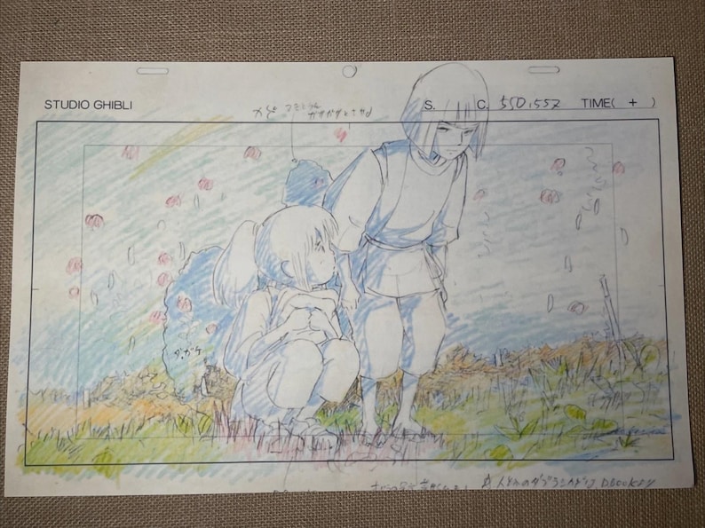 May include: A Studio Ghibli animation cel featuring two anime characters in a field. One character is kneeling, the other standing. The cel has pencil and colored pencil details, with text at the top and bottom.