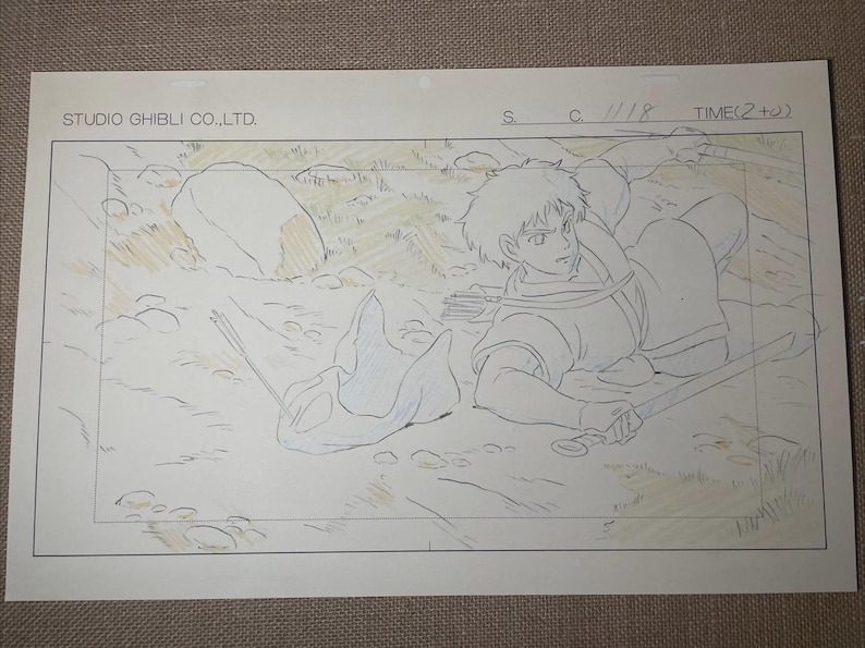 May include: Original animation cel from Studio Ghibli featuring a character with a sword, lying on the ground. The cel is hand-drawn with pencil and colored with light tones. The text "STUDIO GHIBLI CO., LTD." is visible.