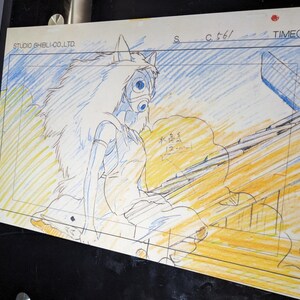 May include: A black and white pencil drawing of a female character with long white hair and a mask. The character is wearing a long white dress and is sitting on a wooden structure. The drawing is on a white background with blue and yellow lines. The text "STUDIO GHIBLI CO. LTD" is in the top left corner. The text "S C.t6/ TIME(3 +0)" is in the top right corner.