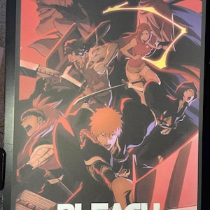 May include: A poster for the anime series Bleach: Thousand-Year Blood War. The poster features the main characters Ichigo Kurosaki, Rukia Kuchiki, and others in a dramatic pose with swords drawn. The background is a vibrant red with black and white accents.