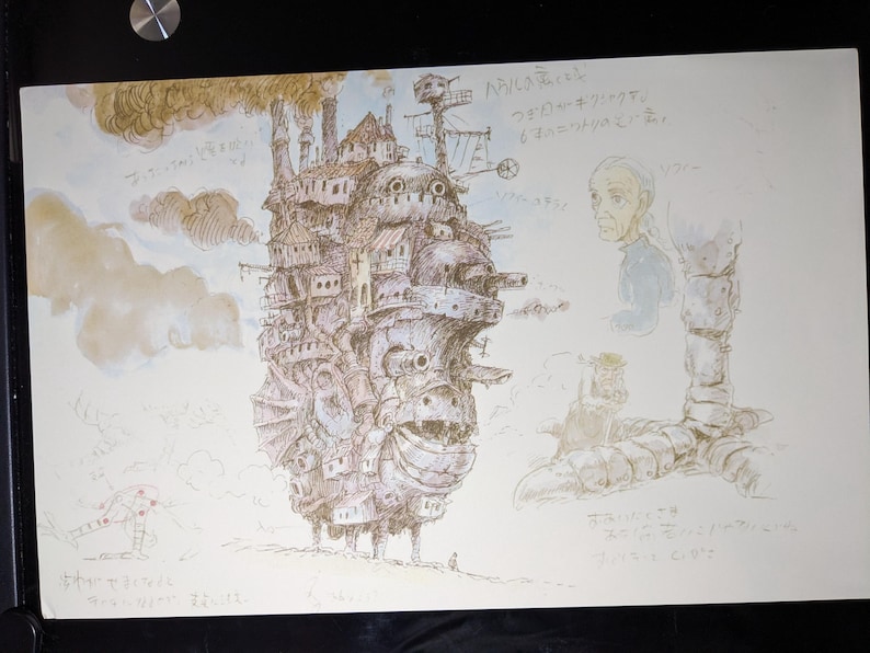 May include: A black and white illustration of a flying city with a large, detailed face. The city is surrounded by clouds and has a large, round window on the side. The text "飛行船" is written in Japanese on the right side of the image.