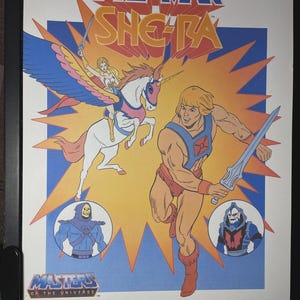 May include: A vintage movie poster for "He-Man and She-Ra: The Secret of the Sword." The poster features He-Man, She-Ra, and other characters from the Masters of the Universe franchise. The poster has a colorful design with text.