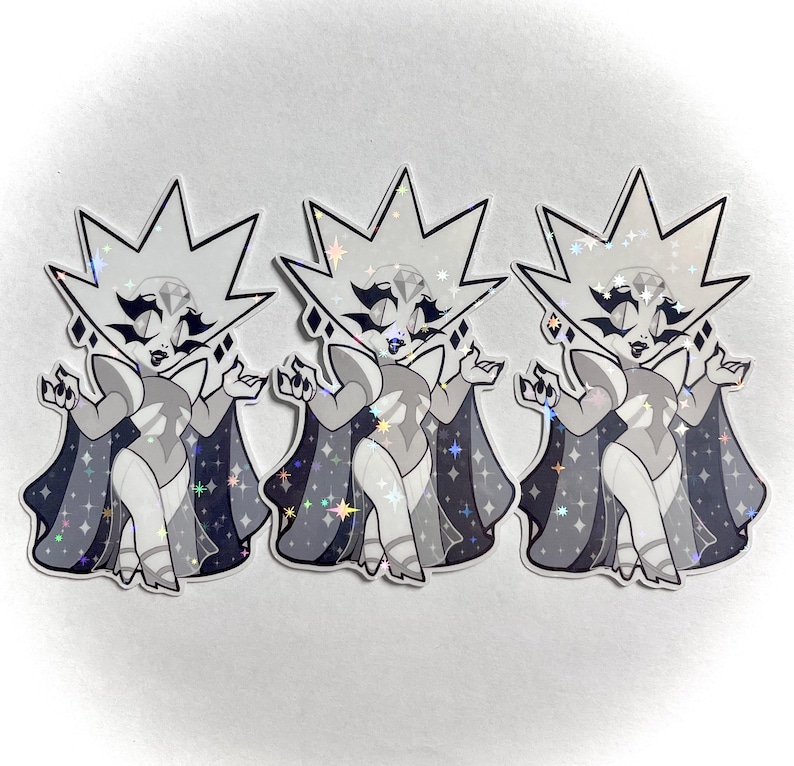 May include: Three stickers featuring a stylized cartoon character with a diamond-shaped head and a cape. The character is primarily gray and white with black accents and a sparkling, iridescent finish. The cape is dark gray with star details.