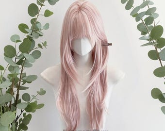May include: A light pink wig with long, layered hair and bangs. The wig is styled on a mannequin head with a white face covering. The text "Justsomestuff4you wig for you" is visible at the bottom of the image.