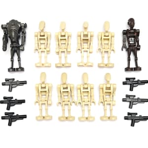 May include: A collection of ten plastic robot action figures and six black plastic toy blasters. The set includes eight tan humanoid droids, one dark gray heavy droid, and one dark brown droid, all featuring articulated limbs and heads.