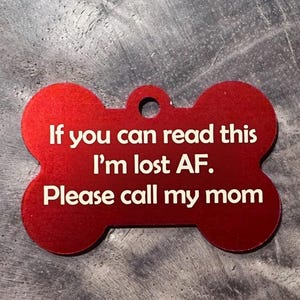 May include: Red bone-shaped dog tag with white text: "If you can read this I'm lost AF. Please call my mom." The tag has a hole for attaching to a collar.