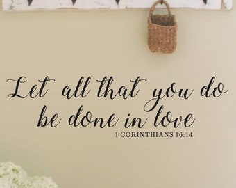 May include: A wall decal with the quote "Let all that you do be done in love" and the scripture reference "1 Corinthians 16:14".