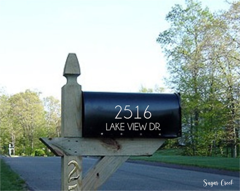 May include: A black mailbox with a white wooden post. The mailbox has the address 2516 Lake View Dr. written on it in white letters.