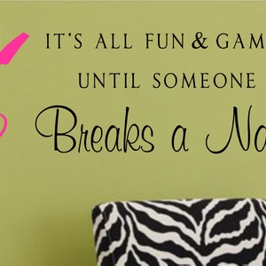 May include: It's all fun and games until someone breaks a nail! Wall decal with a pink nail polish bottle and brush design.