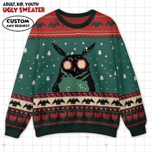May include: Green ugly sweater with a pixelated Mothman design. The sweater features a red and green pattern with bats and Christmas trees. The text "ADULT, KID, YOUTH UGLY SWEATER" and "CUSTOM ANY REQUEST" are visible.