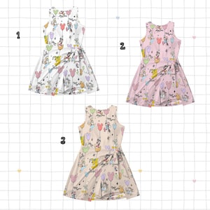 May include: Three sleeveless dresses with a wrap-style design. Each dress features a repeating pattern of cartoon characters, balloons, and stars. The dresses are in white, pink, and beige, with colourful accents. The dresses are suitable for casual wear.
