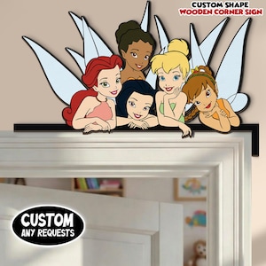 May include: A wooden corner sign featuring six cartoon fairies with colorful outfits and wings. The sign is black and has the text "CUSTOM SHAPE WOODEN CORNER SIGN" and "CUSTOM ANY REQUESTS".