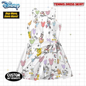 May include: White tennis dress skirt with a Disney character print, including Mickey and Minnie Mouse, and other characters. The dress has a tie waist and is decorated with balloons. The text "Tennis Dress Skirt" is at the top.