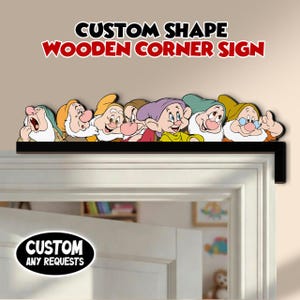 May include: A wooden corner sign featuring the seven dwarfs from Snow White. The sign is black with the dwarfs in various colors and the text "CUSTOM SHAPE WOODEN CORNER SIGN" in red and black. The sign is placed above a white door.