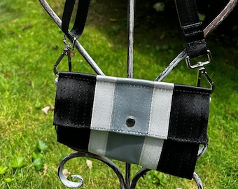 Foldover Crossbody Seatbelt Clutch from FiberTime in Black, White and Silver!