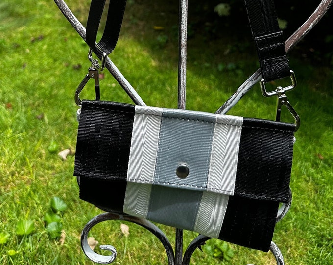 Foldover Crossbody Seatbelt Clutch from FiberTime in Black, White and Silver!