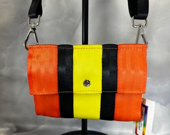 Foldover Crossbody Seatbelt Clutch from FiberTime in Orange, Black and Yellow!