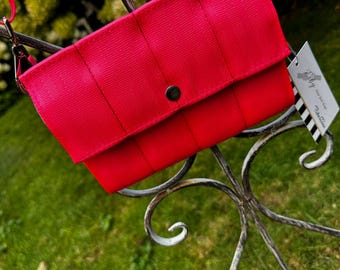 Fluorescent Pink Foldover Crossbody Seatbelt Clutch from FiberTime