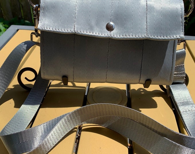 Foldover Crossbody Seatbelt Clutch from FiberTime in Silver!