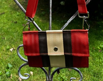 Foldover Crossbody Seatbelt Clutch from FiberTime in Rust, Brown and Light Gold