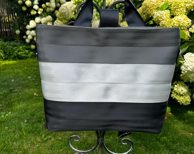 Silver White and Black Convertible Seat Belt Backpack