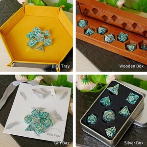 May include: A selection of teal and silver dice sets presented in a yellow dice tray, a wooden box, a gift bag, and a silver box. The gift bag has the text "FOR YOU". The dice are for tabletop games.