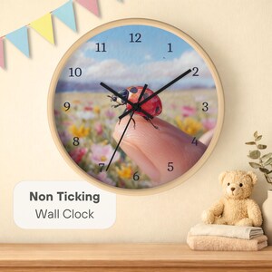May include: A round wall clock with a light wood frame. The clock face features a field of flowers and a ladybug. The text "Non Ticking Wall Clock" is displayed on the bottom left.