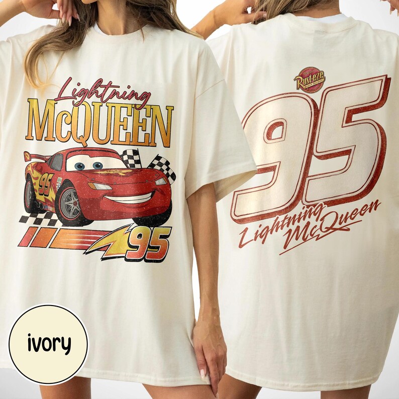 May include: Ivory-colored t-shirts featuring Lightning McQueen from the Cars movie. The front graphic shows McQueen with the number 95 and the text "Lightning McQueen". The back displays a large "95" and "Lightning McQueen" text.
