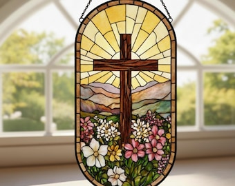 May include: Stained glass window art featuring a wooden cross set against a radiant yellow sunburst. The scene includes rolling hills and a vibrant array of flowers in shades of pink, white, and yellow. The window is framed in a dark brown border and hangs from a chain.