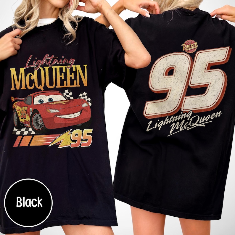 May include: Black t-shirt featuring Lightning McQueen from the Cars movie. The front graphic shows McQueen with the number 95, while the back displays a large number 95 and the Lightning McQueen logo. The shirt has a vintage, distressed look.