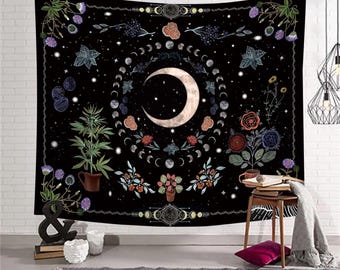 May include: Black tapestry featuring a crescent moon surrounded by phases of the moon and floral elements. The design includes stars, flowers, and botanical illustrations. The tapestry is a decorative wall hanging.