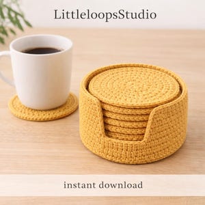 May include: A set of mustard yellow crochet coasters and a holder. The coasters are round and stacked inside a matching holder. A white mug with coffee sits on one of the coasters. The text "LittleloopsStudio" and "instant download" are visible.