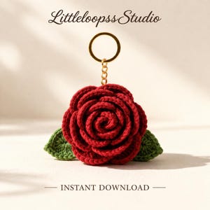 May include: A handmade red crochet rose keychain with green leaves and a gold-colored keyring. The keychain is a floral design with the text "Littleloopss Studio" and "INSTANT DOWNLOAD".