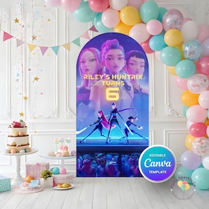 May include: An arched backdrop display featuring a digital illustration of three animated characters with glowing swords, the text "RILEY'S HUNTRIX TURNS 6", and a crowd of creatures below, surrounded by a colourful balloon arch in shades of pink, blue, and yellow.