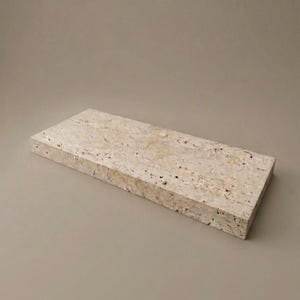May include: A rectangular shelf made of beige travertine stone with a porous, textured surface. The piece features natural veining and small pits characteristic of the stone, with straight, clean edges forming a solid, flat, horizontal slab.