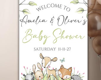 Op de afbeelding: Welkom bij de babyshower van Amelia & Oliver met een bos-thema. Het bord toont een hert, een vos, een konijn, een wasbeer en een egel in een groene bosomgeving. De datum van de babyshower is zaterdag 11-11-27.