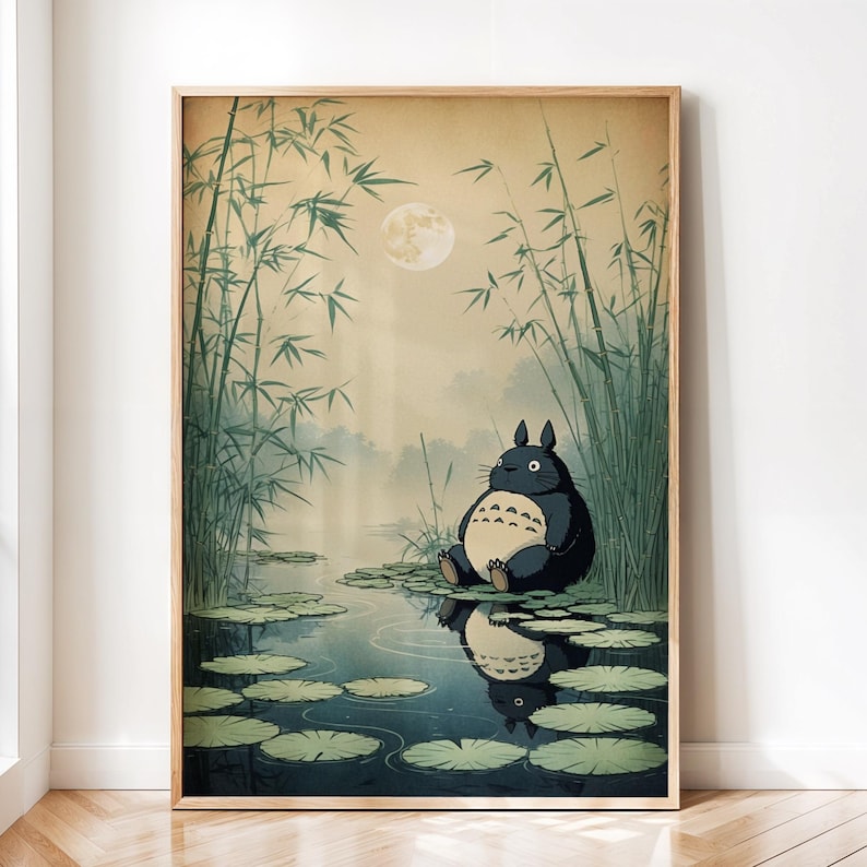 May include: A framed art print depicting a tranquil scene with a large, dark grey creature seated on lily pads in a pond. The background features bamboo stalks, a full moon, and a misty atmosphere, creating a serene, nature-inspired aesthetic.