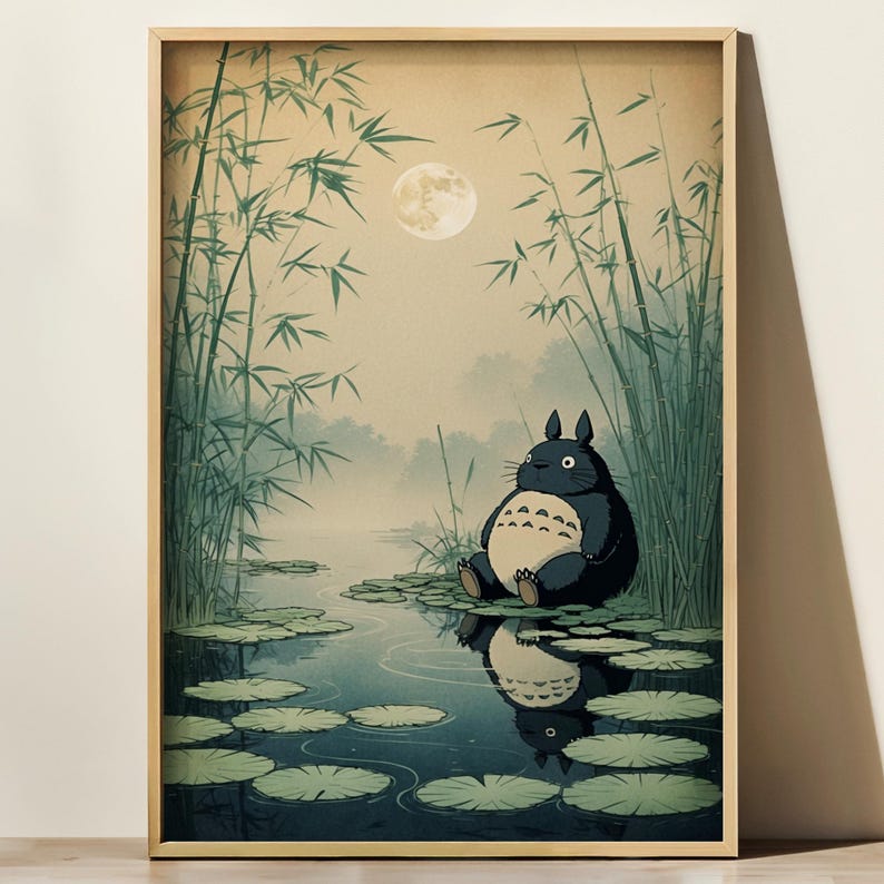 May include: A framed art print depicting a tranquil scene with a large, dark grey creature seated on lily pads in a pond. Tall bamboo stalks frame the water, with a full moon in the sky. The artwork has a soft, watercolour-like quality.