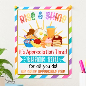 May include: A rectangular sign with a colorful diagonal striped border featuring the text Rise & Shine, It's Appreciation Time! thank you for all you do! WE TRULY APPRECIATE YOU! and illustrations of breakfast foods including pancakes, waffles, and fruit.