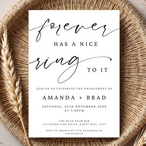 May include: A white wedding invitation with black calligraphy that reads "forever has a nice ring to it". The invitation announces the engagement of Amanda and Brad on Saturday, November 20th at 7:00 PM. The invitation includes the location and RSVP information.