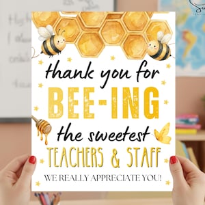 May include: A white ceramic mug with a black handle and the text "But First, Coffee" in a black, bold font. The mug is sitting on a white surface. The mug is approximately 4 inches tall.